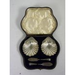 A cased set of two Edwardian silver butter shells, Chester, 1903, including an associated pair of