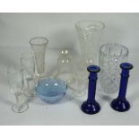 A quantity of assorted glassware, including a pair of blue glass candlesticks, three flower vases