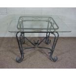 A modern square topped glass and aluminium centre table, with a rounded and bevelled glass top,