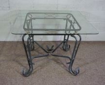 A modern square topped glass and aluminium centre table, with a rounded and bevelled glass top,