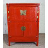 A Chinese red lacquer Wedding Cabinet, Qing Dynasty, with two pairs of cabinet doors, and two