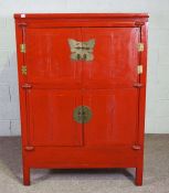 A Chinese red lacquer Wedding Cabinet, Qing Dynasty, with two pairs of cabinet doors, and two
