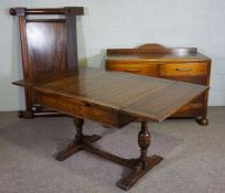 A small oak draw leaf dining table, early 20th century; together with a sideboard, with two