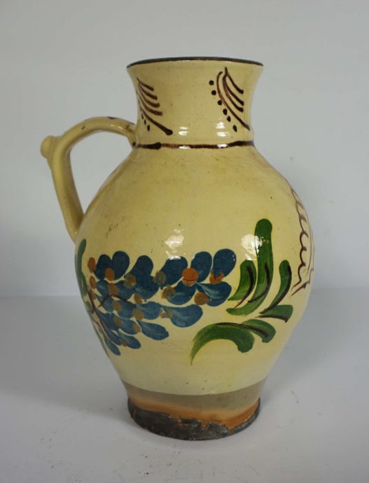 An English slipware puzzle jug, probably West Country, 19th century, decorated with leaves on a