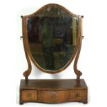 A Regency mahogany toilet mirror, early 19th century, with a shield framed mirror over a three