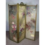 A Victorian style three fold painted and upholstered screen, decorated with roses and clematis,