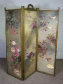 A Victorian style three fold painted and upholstered screen, decorated with roses and clematis,