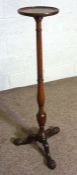 A George III style mahogany torchere, 20th century reproduction, with turned and fluted pillar set