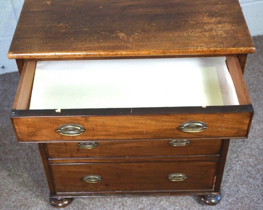 A small mahogany chest of drawers, 19th century, with four long drawers, on compressed bun feet, - Image 3 of 9