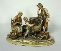 An Italian porcelain figure group of a Knife grinder and family, A Borsato, Milan, 20th century,