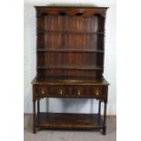 A stained beech dresser, mid 20th century, the rack with two shelves over a base with two drawers,