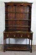 A stained beech dresser, mid 20th century, the rack with two shelves over a base with two drawers,