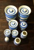 Nine assorted pieces of Cornish ware including two large canisters, made by TG Green & Co.
