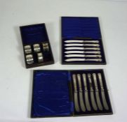 Two cased sets of silver handled fruit knives, and five silver napkin rings.