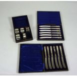 Two cased sets of silver handled fruit knives, and five silver napkin rings.