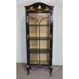 A japanned china cabinet, 20th century, with an arched top, glazed cabinet door opening to