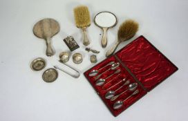 A small assortment of silver, including a dressing set, cased coffee spoons, sugar nips and small