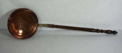 A copper warming pan, 19th century, with turned wooden handle
