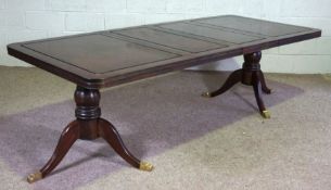 A modern Georgian style extending dining table, hardwood, with two additional leaves, a rounded