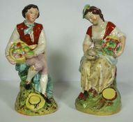 A pair of Staffordshire pottery figures of a Lady and Gallant, mid 19th century, each holding a