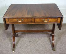 A George III style mahogany sofa table, 20th century, with a rounded rectangular drop leaf top