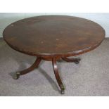 A George IV mahogany breakfast table, 19th century, with a circular tilting top with reeded edge set