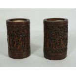 A pair of Chinese bamboo Bitong Brush Pots, Qing Dynasty, of typical cylindrical form, each carved