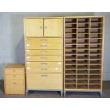 A large shop storage cabinet, with graduated drawers, 175cm high, 87cm wide; together with a matched