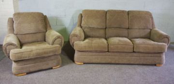 A modern three seat sofa and matching armchair, circa 2002, with beige upholstery, includes fire