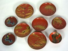 A set of seven assorted Japanese laquered saucers, Meiji period, decorated with Koi, River scenes