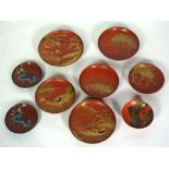 A set of seven assorted Japanese laquered saucers, Meiji period, decorated with Koi, River scenes