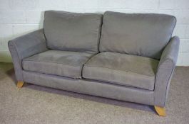 A pair of modern two seat sofas, both upholstered in light grey, on solid lightly tapered feet (