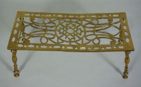 A brass trivet, or iron stand, 19th century, with pierced rectangular top and turned brass legs,