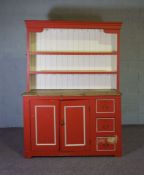 A painted and stripped pine kitchen dresser, 20th century, with a two shelf modern rack, set on an