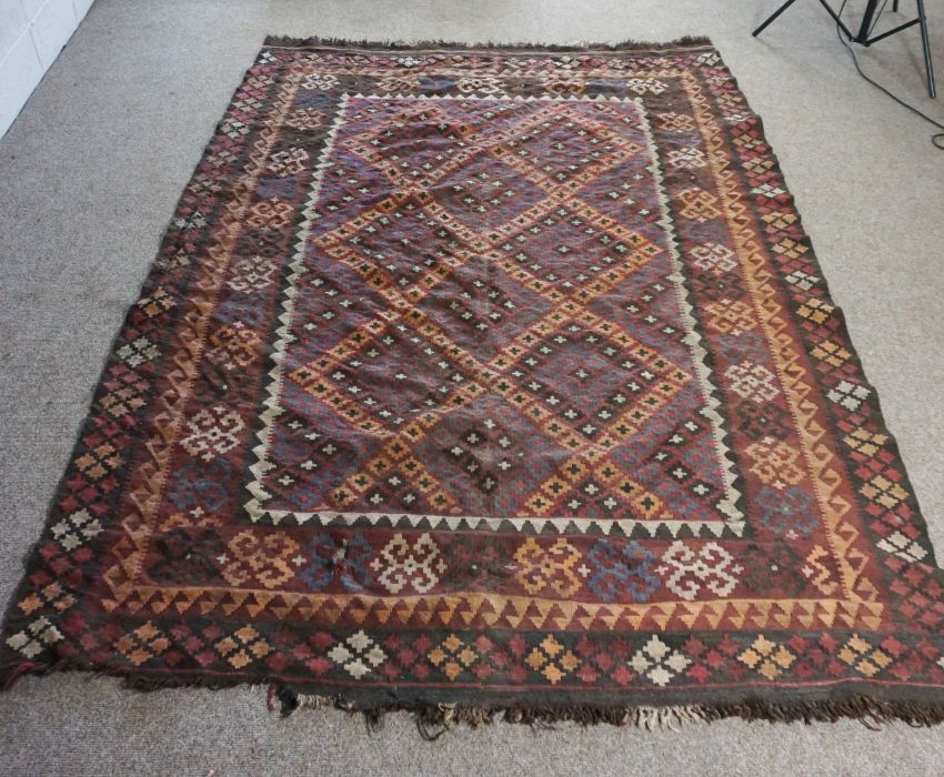 A Kilim rug, 20th century, with geometric lozenges on a brown field, 277cm long, 200cm wide - Image 3 of 6