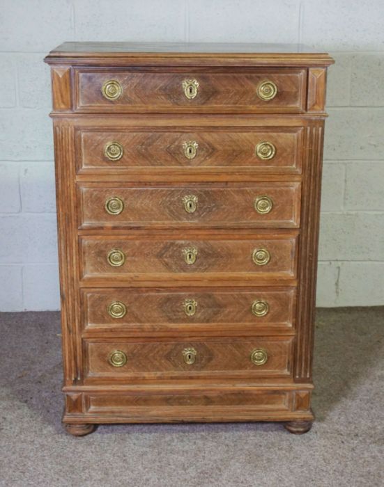 A Louis XVI style walnut chest of drawers, with a moulded top over six drawers, 120cm high, 80cm