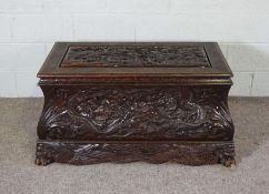 A Chinese carved hardwood chest, early to mid 20th century, the top and front deeply carved with