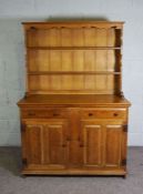 An oak dresser, modern, 20th century, the rack with two shelves over two drawers and two cabinets,