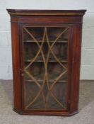 A George III mahogany corner cabinet, with a single glazed door and boxwood line inlays, 105cm high,