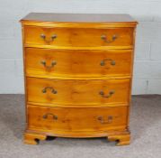 A modern yew wood veneered bow front chest of drawers, 108cm high, 91cm wide