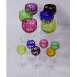 A large assortment of glassware, including a set of coloured flashed glass goblets, in cranberry,