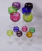 A large assortment of glassware, including a set of coloured flashed glass goblets, in cranberry,
