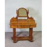 A Victorian mahogany dressing table, circa 1870, with arched mirror over three small drawers, the