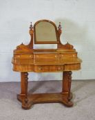 A Victorian mahogany dressing table, circa 1870, with arched mirror over three small drawers, the