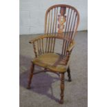 A Victorian ash framed Windsor armchair, circa 1870, with a high arched back, fretwork spat and