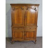 A compact walnut 18th century style armoire, Modern, with two moulded cabinet doors over two small