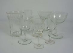 A fine set of Edwardian etched table glasses, including a eight champagne bowls, eight martini