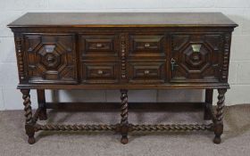 A Jacobean revival oak sideboard, circa 1900, with a rectangular top over two central moulded and