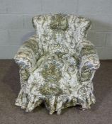 A Victorian tub armchair, with turned feet and brass castors, 80cm high