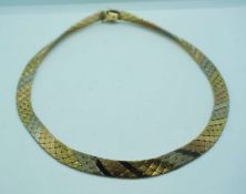 An 18 carat gold Oritalia three coloured gold necklace ribbon scale necklace, the clasp stamped 750,